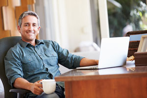 Man at desk with computer studying